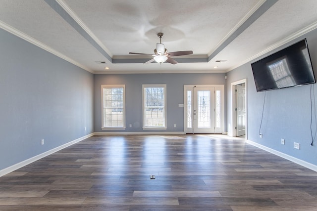 empty room featuring ceiling fan, ornamental molding, and a raised ceiling