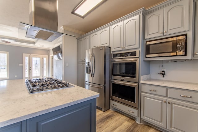 kitchen with range hood, appliances with stainless steel finishes, and gray cabinetry