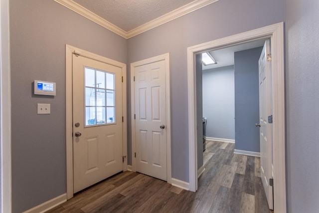 foyer with dark wood-type flooring, a textured ceiling, and ornamental molding