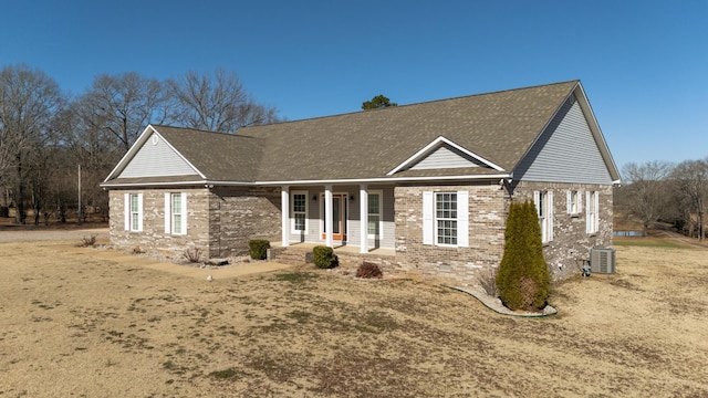 view of front of home with central AC unit, a front lawn, and a porch