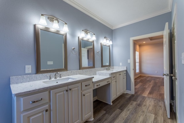 bathroom with vanity, crown molding, and hardwood / wood-style flooring