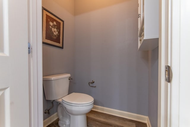 bathroom with toilet and hardwood / wood-style floors