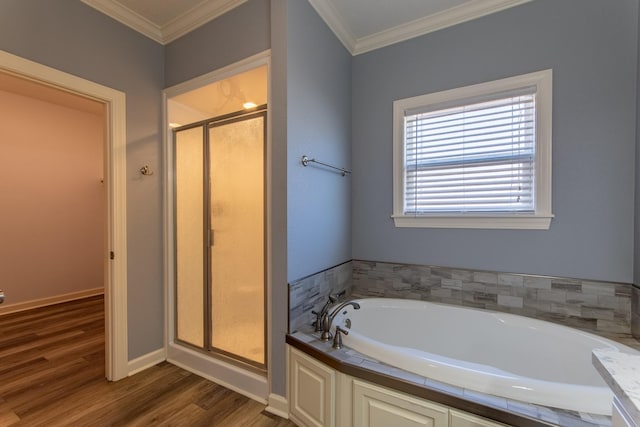 bathroom featuring hardwood / wood-style flooring, crown molding, and separate shower and tub