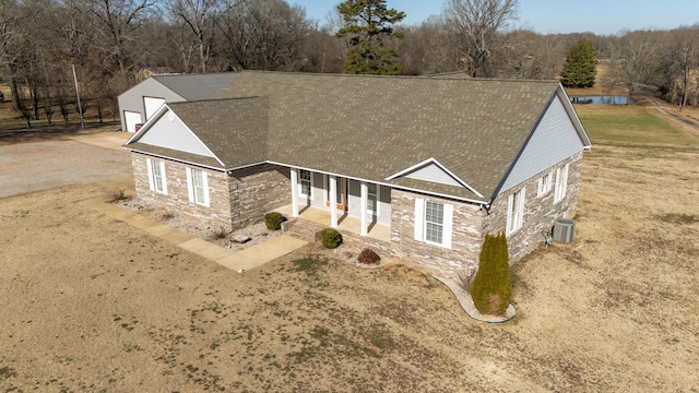 view of front facade with a patio area, a front yard, and central air condition unit