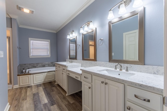 bathroom featuring hardwood / wood-style floors, a bathtub, vanity, and crown molding