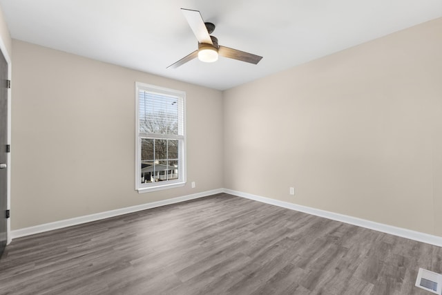 empty room with ceiling fan and wood-type flooring