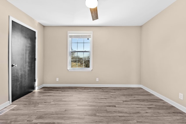 spare room featuring ceiling fan and light hardwood / wood-style flooring