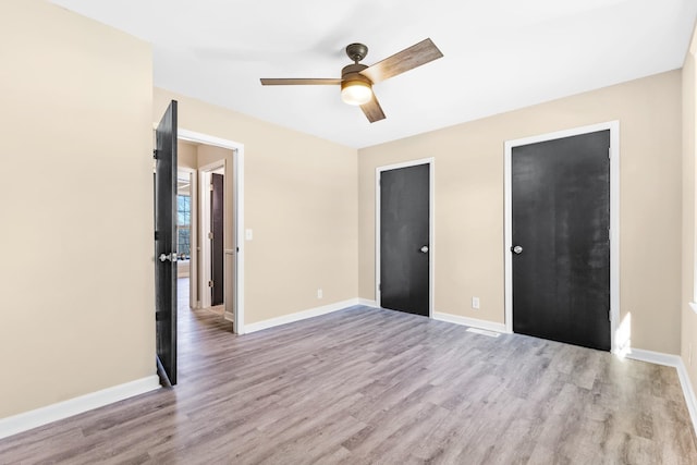 unfurnished bedroom featuring light wood-type flooring and ceiling fan