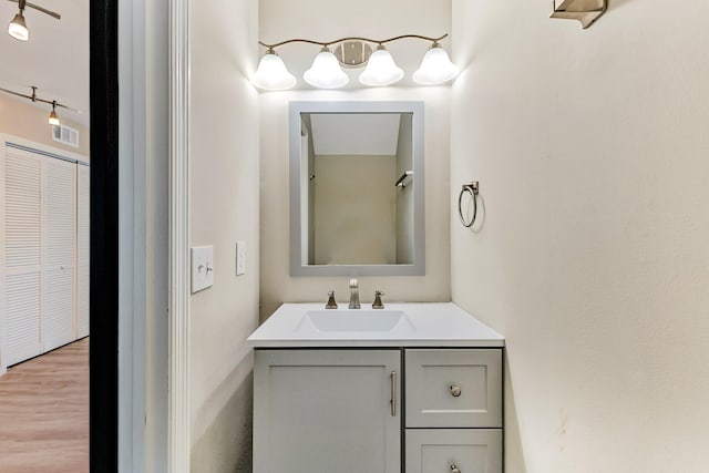 bathroom featuring vanity and hardwood / wood-style flooring