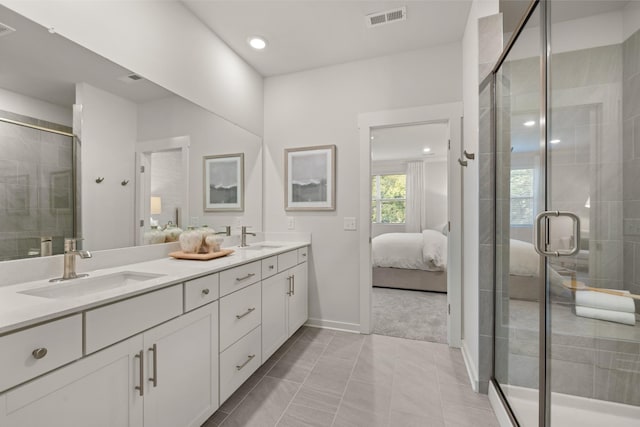 bathroom with walk in shower, vanity, and tile patterned flooring