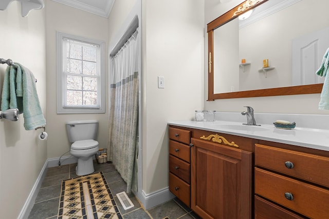 bathroom featuring toilet, vanity, and crown molding