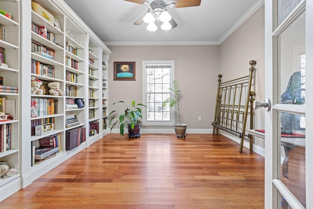 interior space with ceiling fan, light wood-type flooring, and ornamental molding