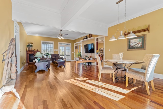 dining room featuring ceiling fan, hardwood / wood-style floors, crown molding, and french doors