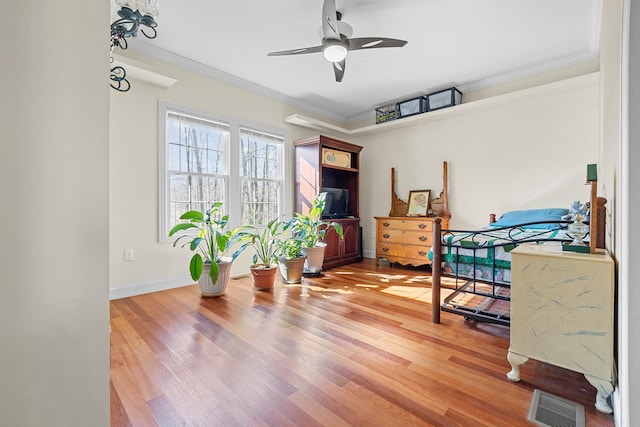 bedroom with ornamental molding and wood-type flooring