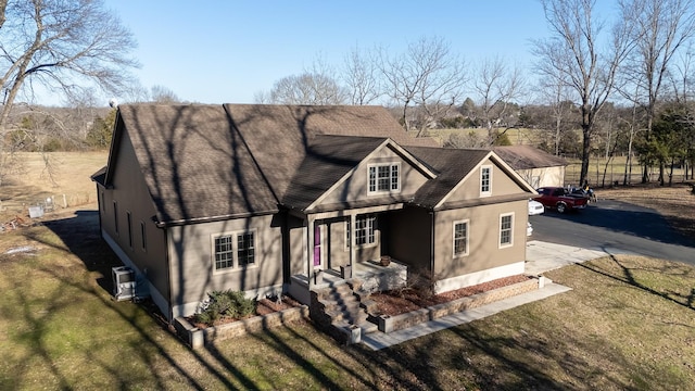 rear view of house featuring a lawn