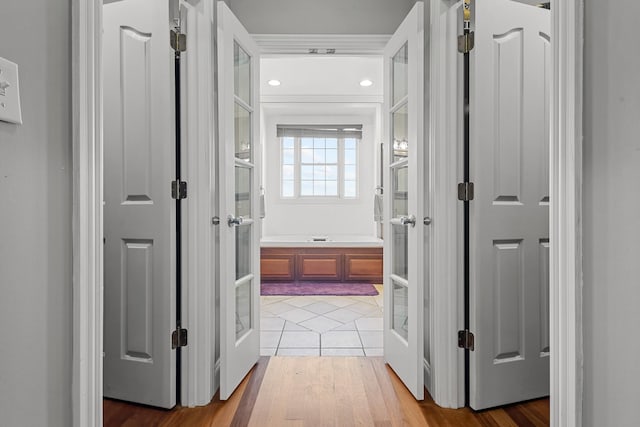 corridor featuring french doors and light hardwood / wood-style flooring