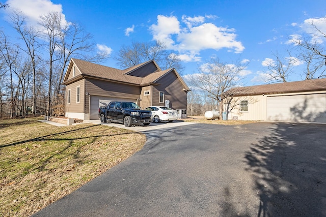 view of home's exterior featuring a garage and a lawn