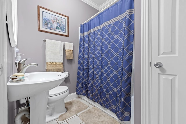 bathroom with toilet, tile patterned flooring, and ornamental molding