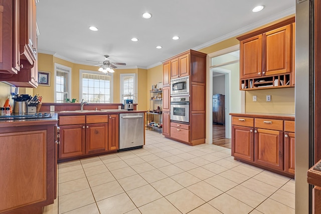 kitchen with kitchen peninsula, ceiling fan, appliances with stainless steel finishes, crown molding, and sink