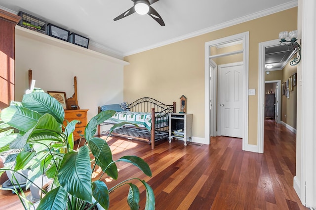 bedroom with ceiling fan, dark hardwood / wood-style floors, and ornamental molding