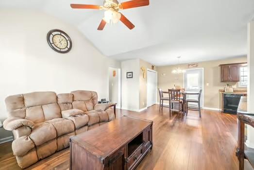 living room with hardwood / wood-style flooring, beverage cooler, ceiling fan, and vaulted ceiling