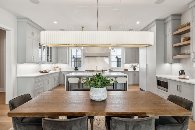 dining space with light wood finished floors and recessed lighting