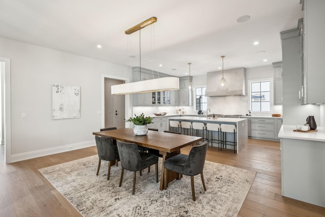 dining space with recessed lighting, baseboards, and light wood finished floors