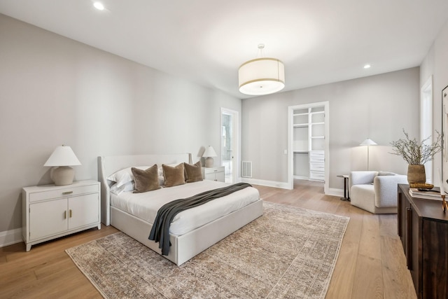 bedroom with light wood-type flooring, visible vents, baseboards, and recessed lighting