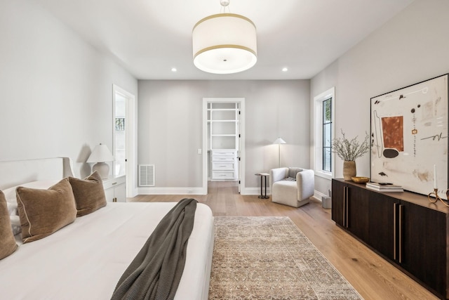 bedroom with light wood-style floors, recessed lighting, visible vents, and baseboards