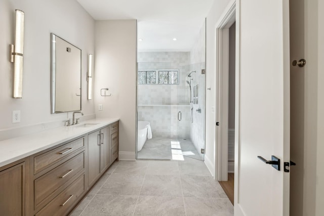 full bath featuring a stall shower, a soaking tub, vanity, and baseboards