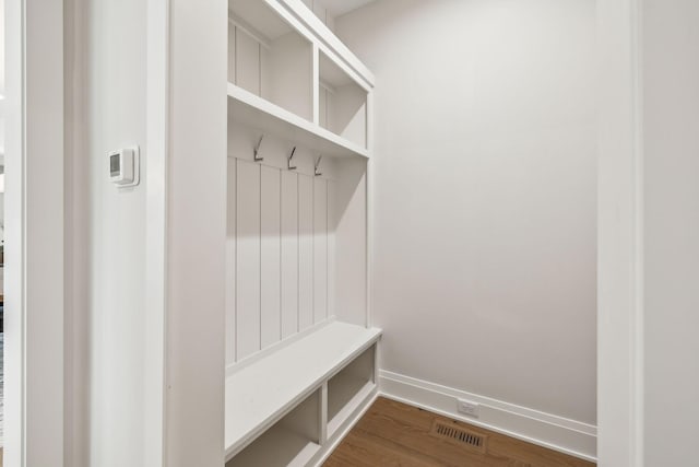 mudroom featuring dark wood-style floors, baseboards, and visible vents