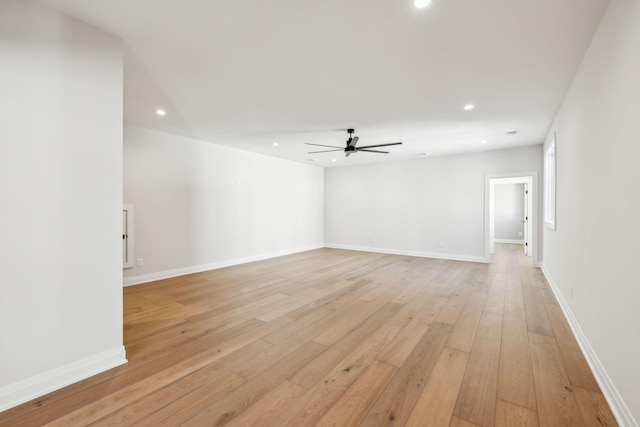 spare room featuring baseboards, recessed lighting, a ceiling fan, and light wood-style floors