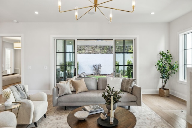 living room featuring baseboards, wood finished floors, and recessed lighting