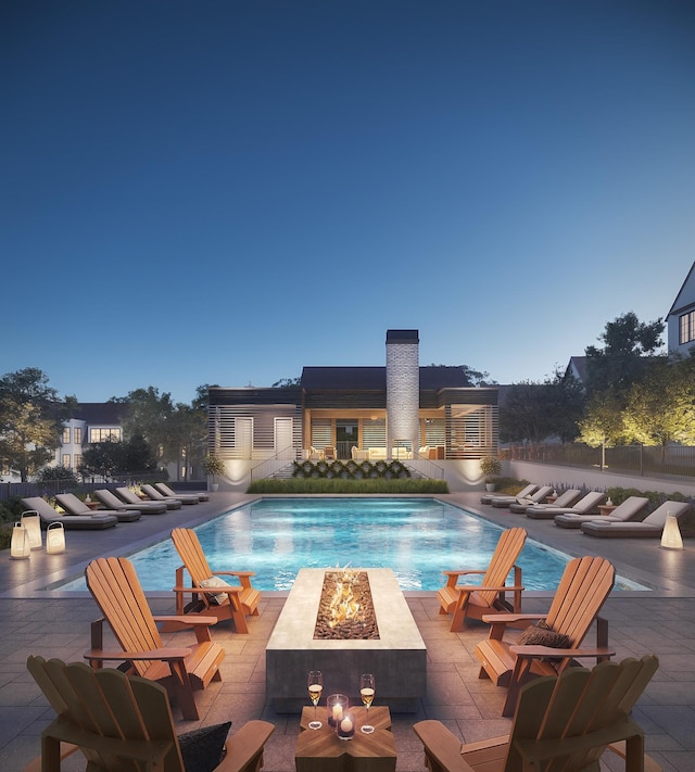 community pool with a patio and an outdoor fire pit