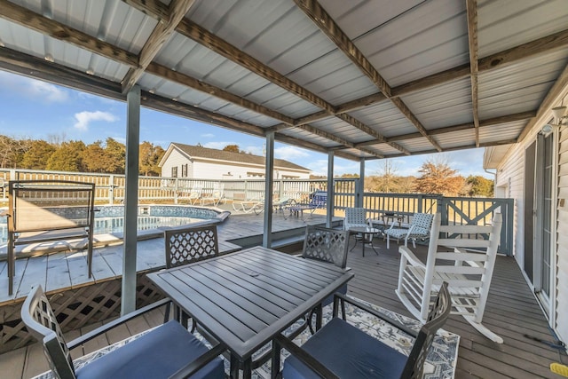 deck featuring a fenced in pool