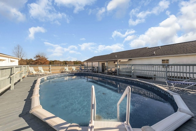 view of pool with a wooden deck