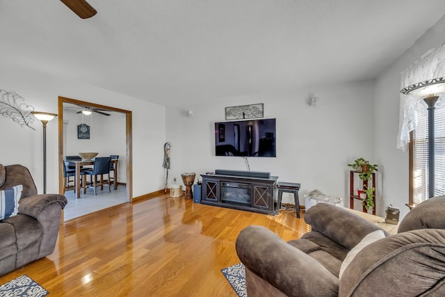 living room featuring hardwood / wood-style floors and ceiling fan