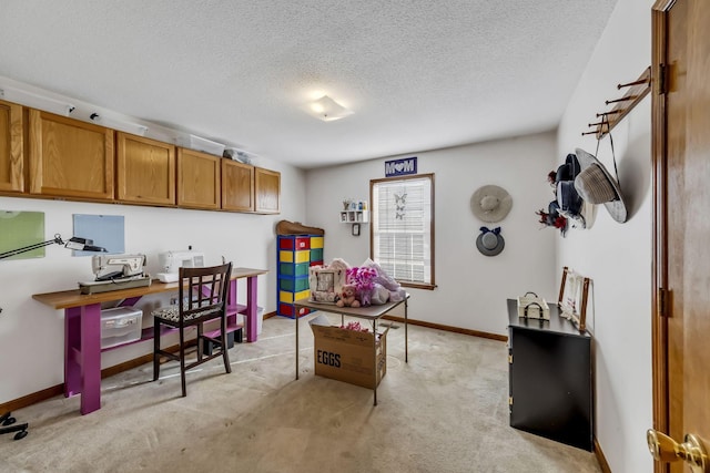 office area featuring light colored carpet and a textured ceiling