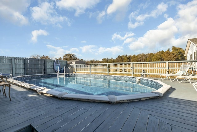 view of swimming pool with a deck