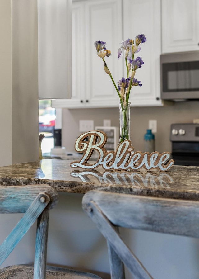 room details featuring appliances with stainless steel finishes and white cabinetry