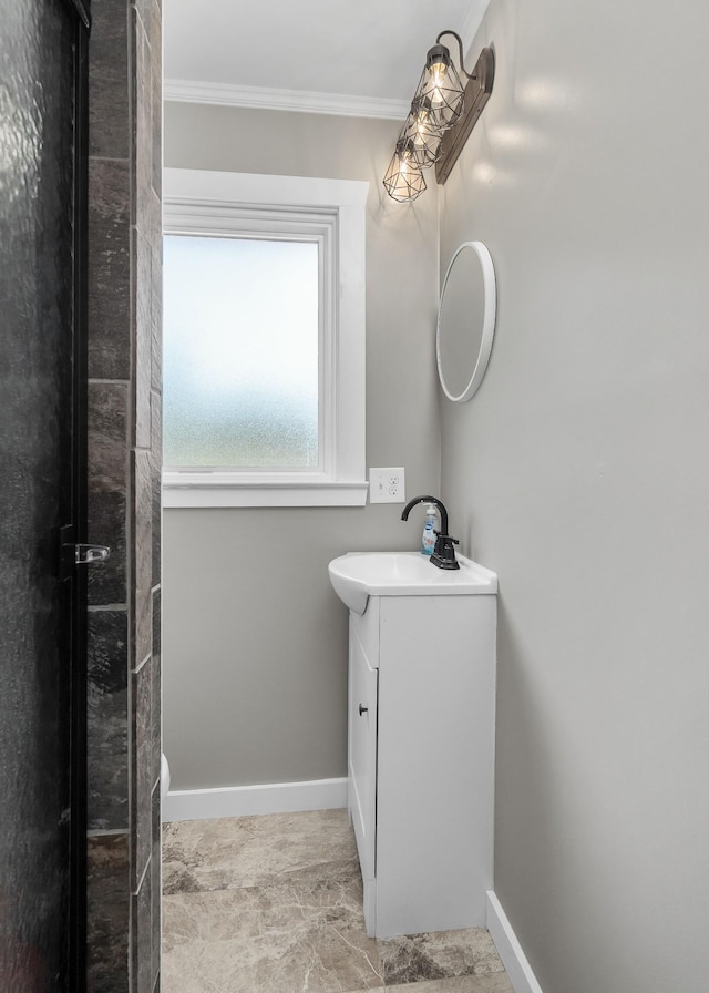 bathroom featuring crown molding and vanity