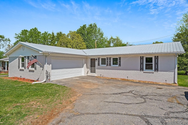 ranch-style home with a garage and a front yard