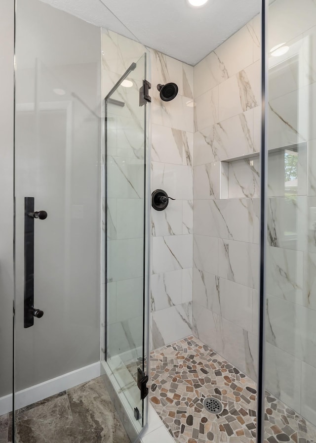 bathroom featuring a shower with door