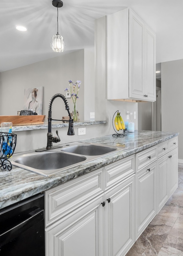 kitchen featuring decorative light fixtures, dishwasher, white cabinets, and sink