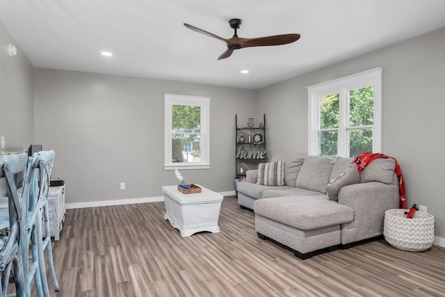 living room featuring light wood-type flooring and ceiling fan