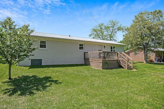 back of property featuring a deck and a yard