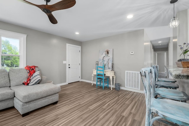 living room featuring hardwood / wood-style flooring and ceiling fan