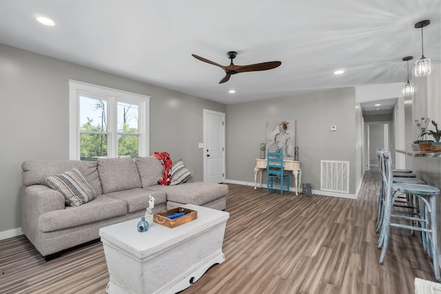 living room with ceiling fan and wood-type flooring