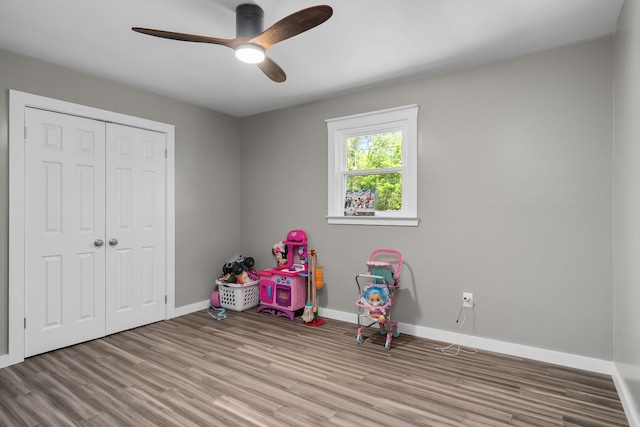 game room with ceiling fan and light wood-type flooring