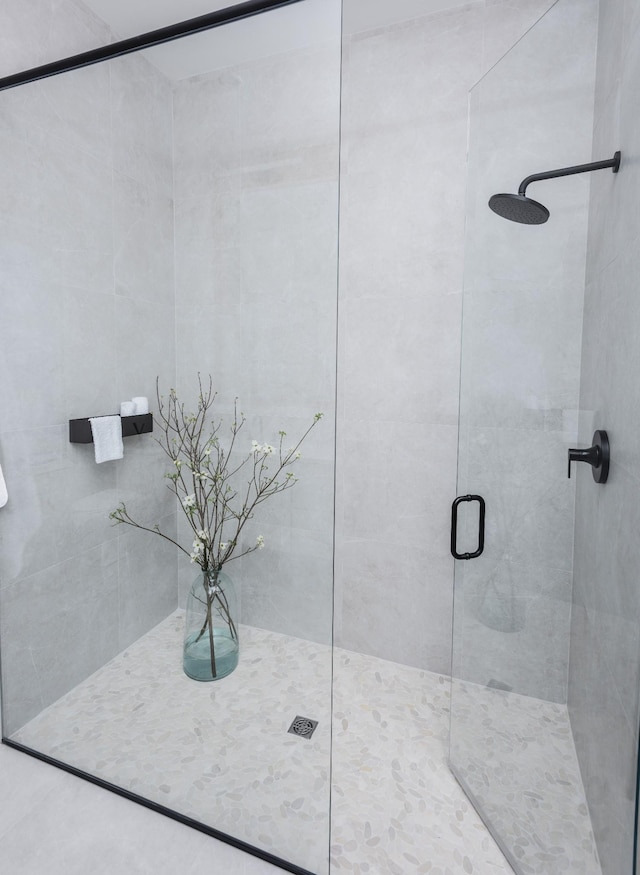 bathroom featuring a shower with door